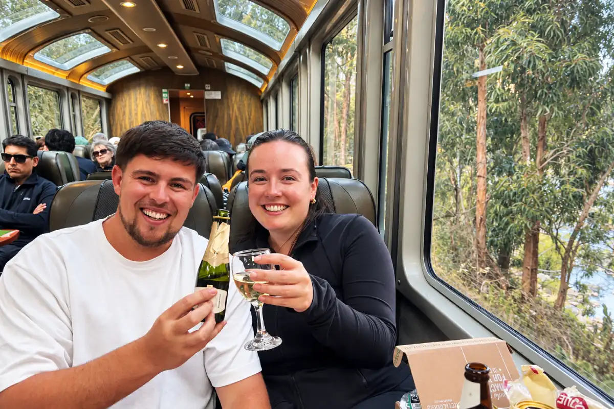 Viajeros brindando en tren panorámico a Machu Picchu | Cocatambo