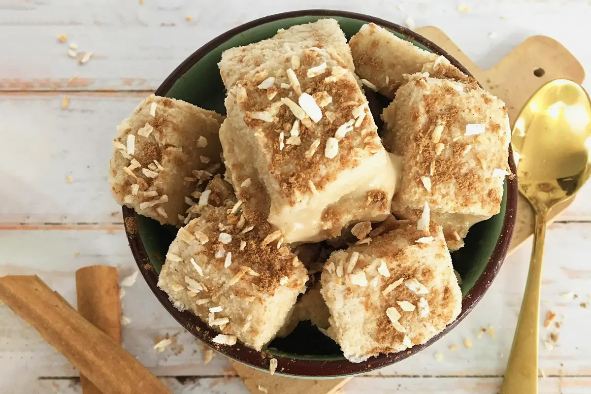 Queso Helado en cuadrados, con coco rallado y canela, servidas en un bowl.